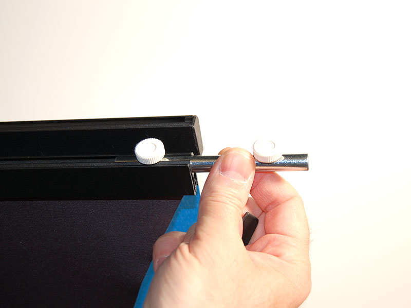 Close Up of Banner Stand Connector Pin - Keeps Top of Banner Stand Even - Shown inserted into one stand - Header end cap must be removed for pin to slide into header. Tight thumb screws to set pin