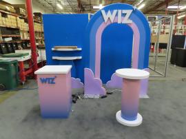 Custom Symphony Portable SYK-1038 Display with Fabric and Direct Print Graphics, Shelves, Rainbox Aero Tube Frame, Monitor Mount, Square Reception Counter, and Small Bistro Table -- View 2