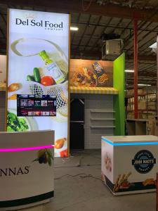 RENTAL: Custom Peninsula Design with Gravitee Storage Closet @ 80" Wide x 42" Deep x 190" High with Locking Door, Front Single-Sided 16 ft. High Lightbox, Custom (Distributor Provided) Awnings, Large Monitor Mount, 55" Monitor with HDMI Cable, (6) 39" Wid