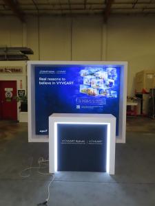 Modified VK-1340 Custom Exhibit with Backlit SEG Fabric Graphic and MOD-1563 Counter with LED Accent Lights and Locking Storage